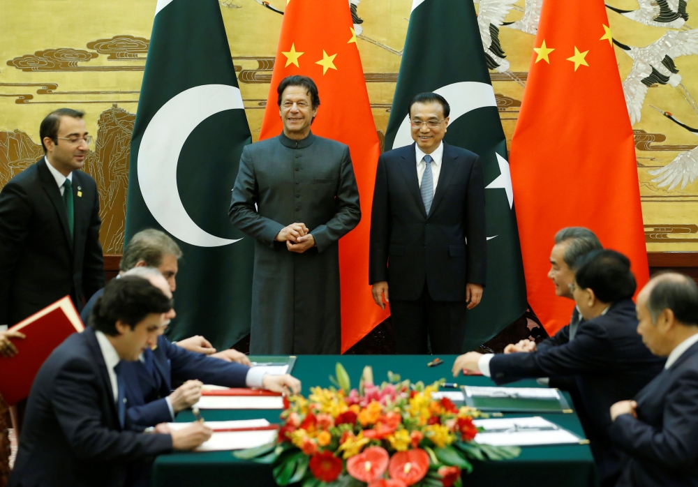 Pakistani Prime Minister Imran Khan, center left, and Chinese Premier Li Keqiang attend a signing ceremony at the Great Hall of the People in Beijing in this Nov. 3, 2018 file photo. — Reuters