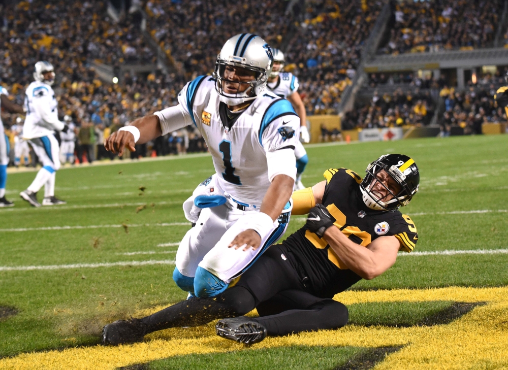 Carolina Panthers quarterback Cam Newton (1) is pressured into throwing a pick six  interception by Pittsburgh Steelers linebacker T.J. Watt (90 in the first quarter at Heinz Field. — Reuters