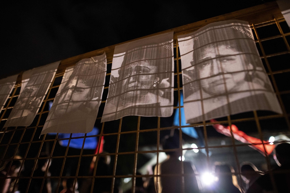 College students hold a protest to mark the corruption conviction of former first lady and congresswoman Imelda Marcos at the University of the Philippines in Manila on Friday. — AFP