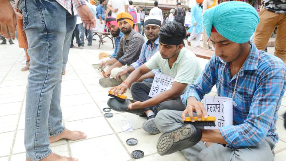 


Members of an elementary teachers union polish shoes in Amritsar during a protest against government to demand jobs. — AFP