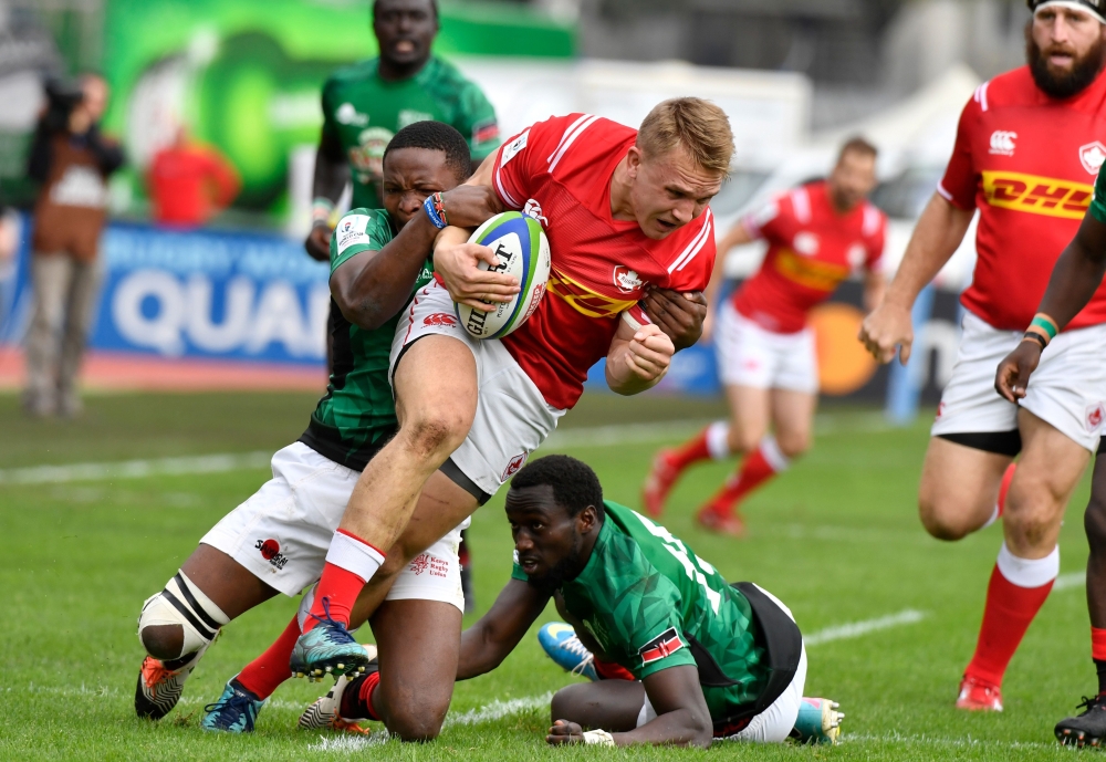 Canada's center Ben Lesage (C) is tackled during the 2019 Japan Rugby Union World Cup qualifying match between Canada and Kenya at The Delort Stadium in Marseille on Sunday. — AFP