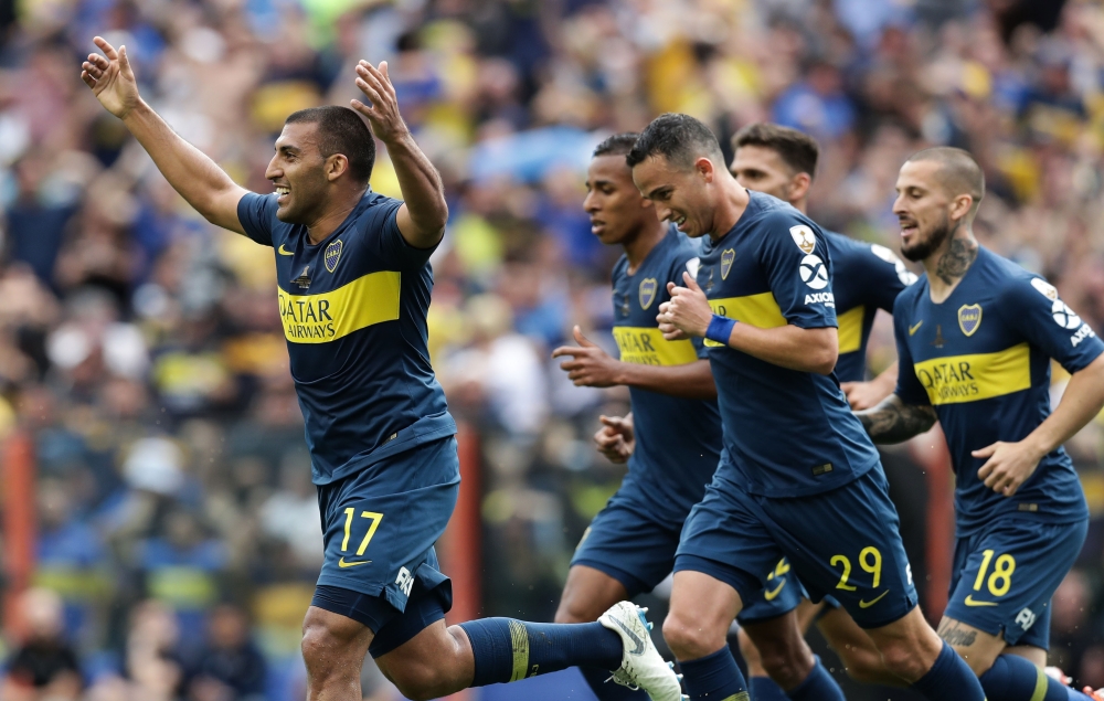 


Boca Juniors' Ramon Abila (L), celebrates after scoring against River Plate during their first leg match of the all-Argentine Copa Libertadores final, at La Bombonera stadium in Buenos Aires, on Sunday. — AFP