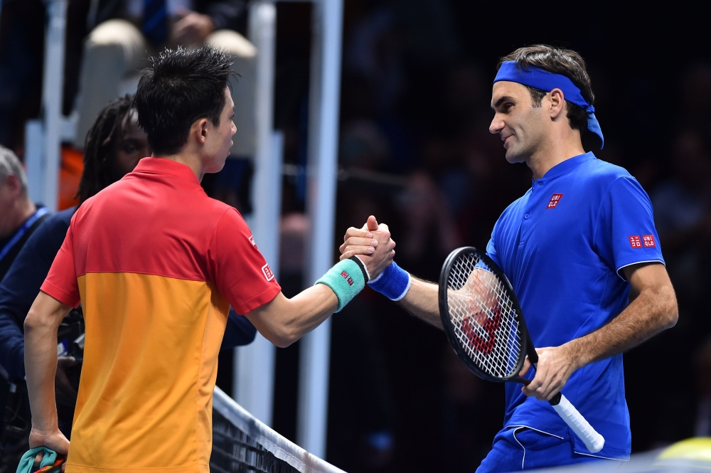 


Japan's Kei Nishikori (L) greets Switzerland's Roger Federer after winning their singles round robin match 7-6, 6-3 on day one of the ATP World Tour Finals tennis tournament at the O2 Arena in London on Sunday. — AFP