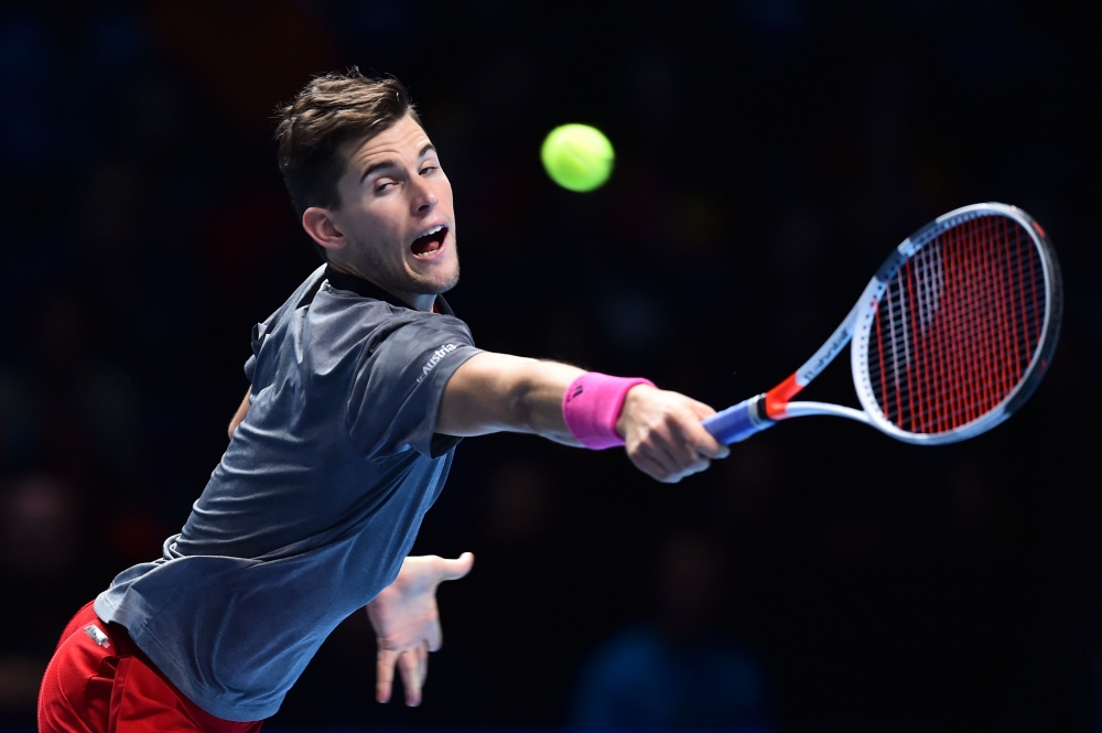 


Austria’s Dominic Thiem returns against Switzerland’s Roger Federer during their men’s singles round-robin match on day three of the ATP World Tour Finals tennis tournament at the O2 Arena in London on Tuesday. —  AFP