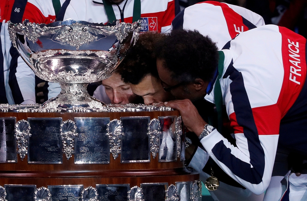 


Fle photo shows France captain Yannick Noah and Jo-Wilfried Tsonga kissing the trophy after winning the Davis Cup Final against Belgium last year at the Stade Pierre Mauroy, Lille, France. — Reuters