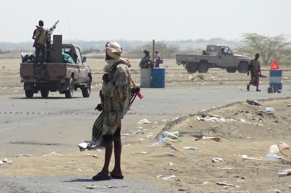 Yemeni pro-government forces gather at a checkpoint in a street on the eastern outskirts of Hodeida. — AFP