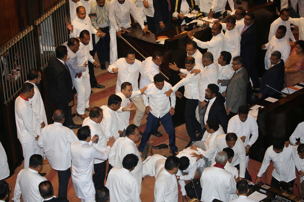 Scuffles between Sri Lankan parliament members are seen during the parliament session in Colombo on Thursday. — Reuters