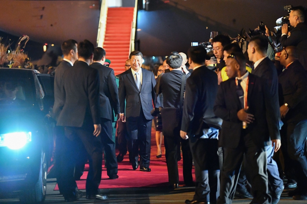 China's President Xi Jinping walks past officials after arriving at Port Moresby International Airport on Thursday, ahead of Asia-Pacific Economic Cooperation (APEC) Summit. — AFP