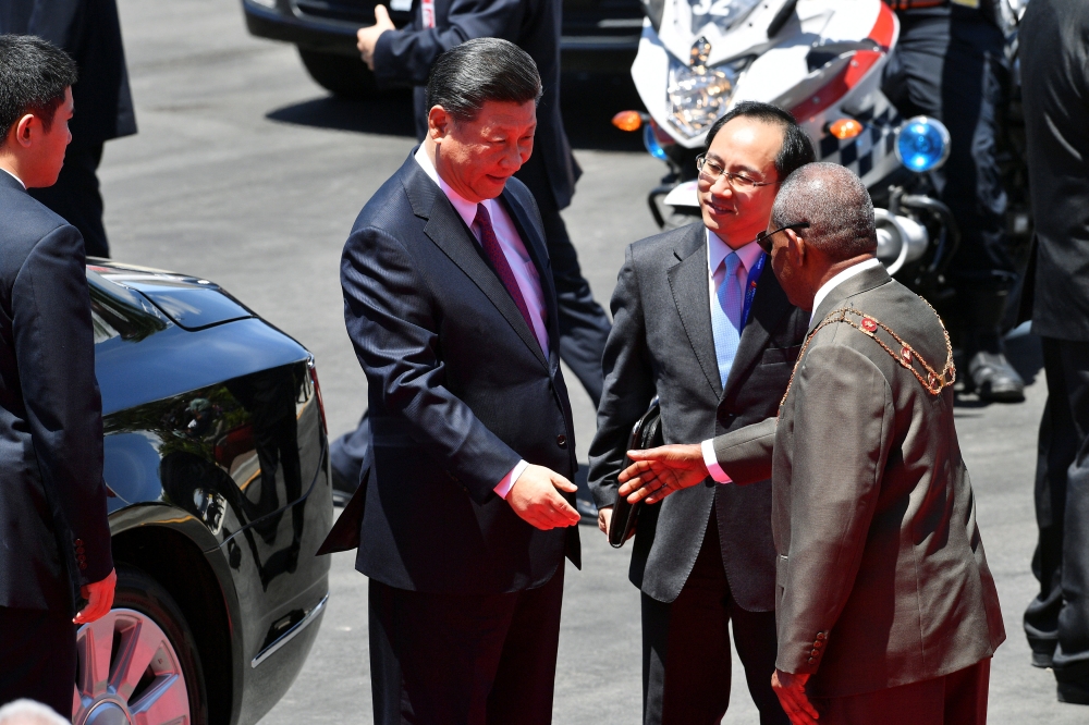 China's President Xi Jinping shakes hands with Governor General Bob Dadae after a welcoming ceremony at Parliament House in Port Moresby on Friday, ahead of the Asia-Pacific Economic Cooperation (APEC) Summit. — Reuters