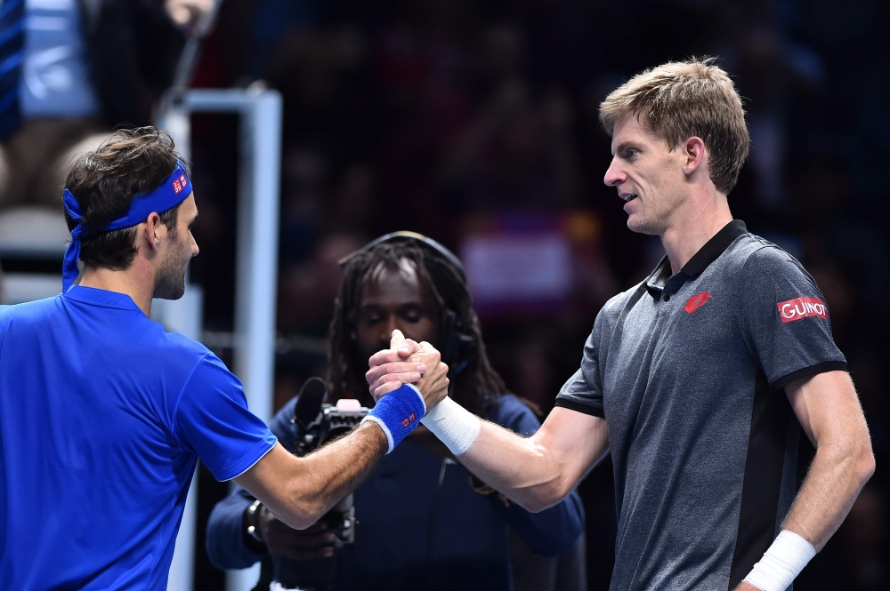 Switzerland's Roger Federer (L) shakes hands with South Africa's Kevin Anderson (R) after Federer won their men's singles round-robin match on day five of the ATP World Tour Finals tennis tournament at the O2 Arena in London on Thursday. — AFP