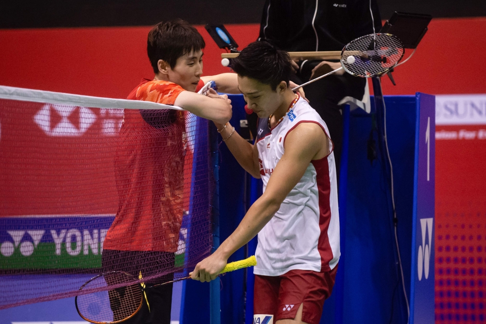 South Korea's Son Wan-ho hits a return against Kento Momota of Japan in their men's singles semifinal match at the Hong Kong Open badminton tournament on Saturday. — AFP