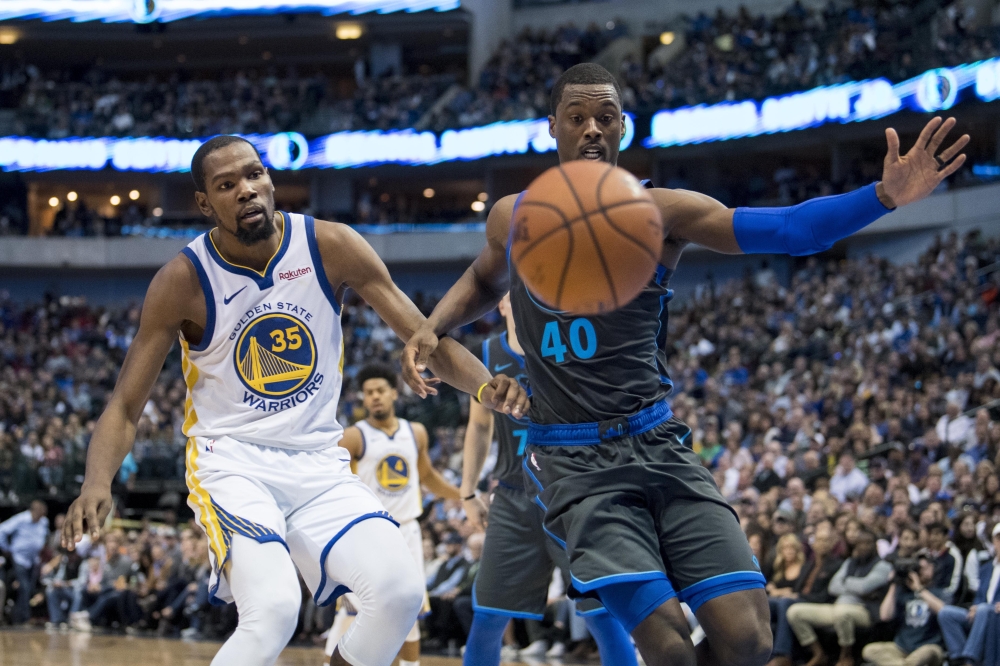 Golden State Warriors forward Kevin Durant (35) and Dallas Mavericks forward Harrison Barnes (40) chase a loose ball during the second half at the American Airlines Center. — Reuters