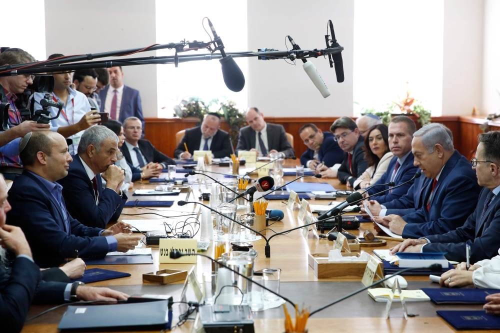 


Israeli Prime Minister Benjamin Netanyahu (2nd right), Minister of Education Naftali Bennett (1st left) and finance minister Moshe Kahlon (2nd left) attend a Cabinet meeting in occupied Jerusalem, Sunday. — AFP