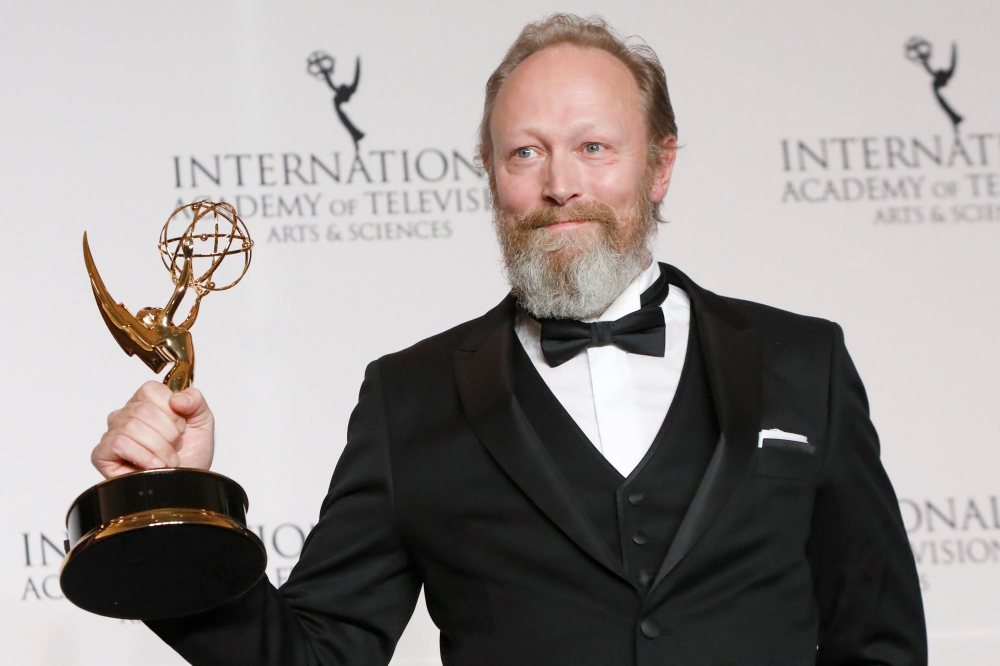 Danish actor Lars Mikkelsen poses with award for Performance by an Actor for his role in Herrens Veje (Ride Upon the Storm) at the International Emmy Awards in Manhattan, New York City. — Reuters