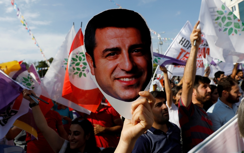 


A supporter of the pro-Kurdish Peoples’ Democratic Party (HDP) holds a mask of their jailed former leader and presidential candidate Selahattin Demirtas during a rally in Ankara, Turkey, in this June 19, 2018, file photo. — Reuters