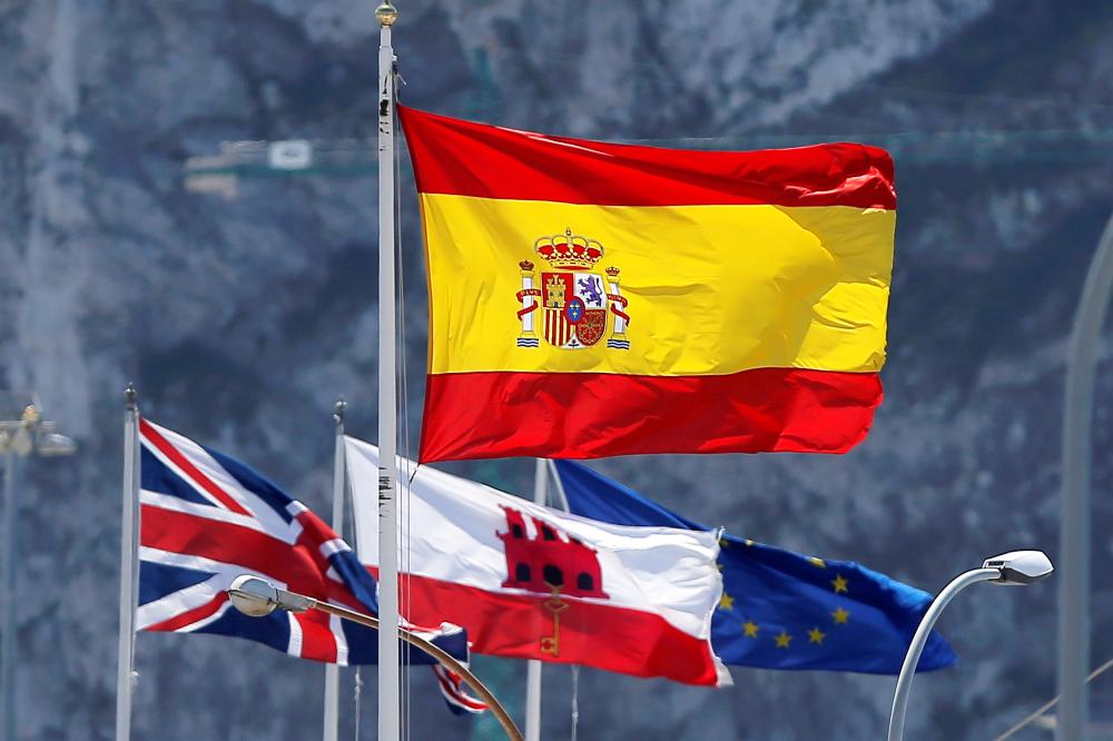 A Spanish flag, top, British union flag, left, the Gibraltarian flag, center, and the European Union flag fly at the border of Spain with the British territory of Gibraltar, historically claimed by Spain, as they are seen from La Linea de la Concepcion, Spain, in this April 18, 2018 file photo. — Reuters