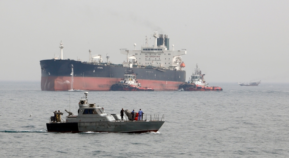 In this file photo taken on March 12, 2017, an Iranian military speedboat patrols the waters as a tanker prepares to dock at the oil facility in the Khark Island, Iran. The US slapped fresh sanctions on Iran Tuesday, accusing it of creating a complex web of Russian cut-out companies and Syrian intermediaries to ship oil to Damascus, which in turn bankrolled Hezbollah and Hamas. — AFP