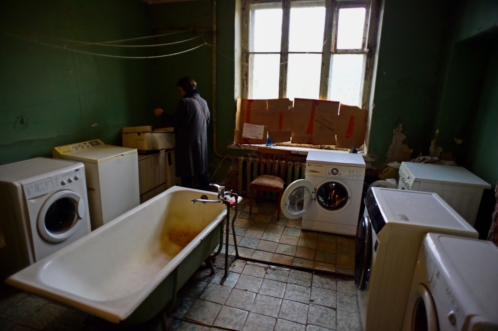 A woman stands in the bathroom of the communal apartment on Detskaya Street in Saint Petersburg in this Oct. 23, 2018 file photo. — AFP