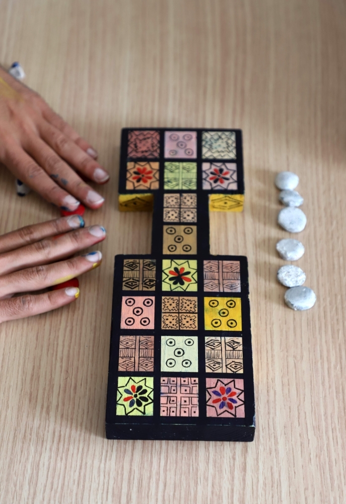 Iraqi artist Hoshmand Mofaq and British archeologist Ashley Barlow (left) play an ancient board game, known as the Royal Game of Ur, in the northern Iraqi city of Raniey. Originating nearly 5,000 years ago in what would become Iraq, the Royal Game of Ur mysteriously died out — until Muwafaq resurrected it by making his own decorated wooden board. — AFP

 / AFP / SHWAN MOHAMMED