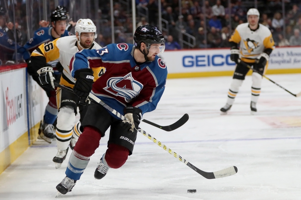 Alexander Kerfoot No. 13 of the Colorado Avalanche advances the puck against the Pittsburgh Penguins at the Pepsi Center on Wednesday in Denver, Colorado. — AFP