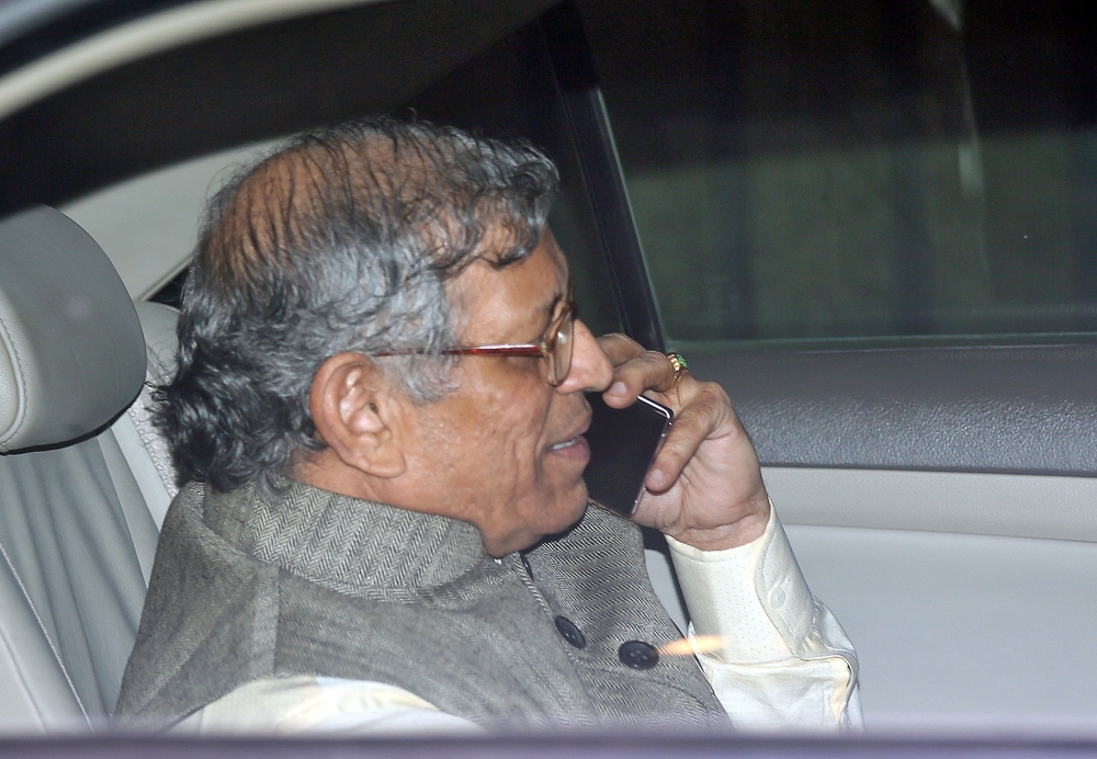 S. Gurumurthy, a member in the central board of directors of the Reserve Bank of India (RBI), speaks on his mobile phone as he leaves after a board meeting at the RBI headquarters in Mumbai, India, in this recent photo. — Reuters