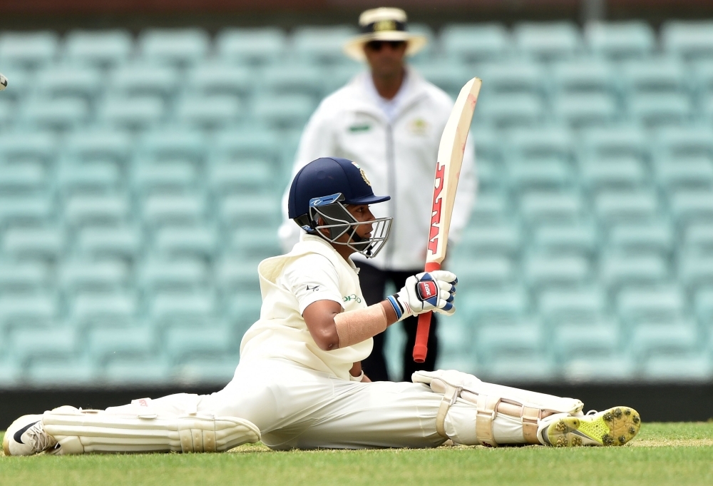 India's batsman Prithvi Shaw falls to the ground after playing a shot on the second day of the tour match against Cricket Australia XI at the SCG in Sydney on Thursday. — AFP 