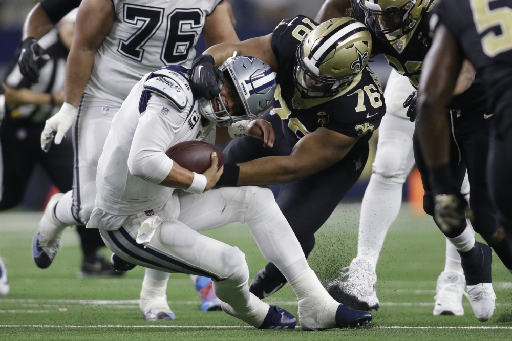 Dallas Cowboys quarterback Dak Prescott (4) is tackled by New Orleans Saints defensive tackle Taylor Stallworth (76) in the fourth quarter at AT&T Stadium. — Reuters