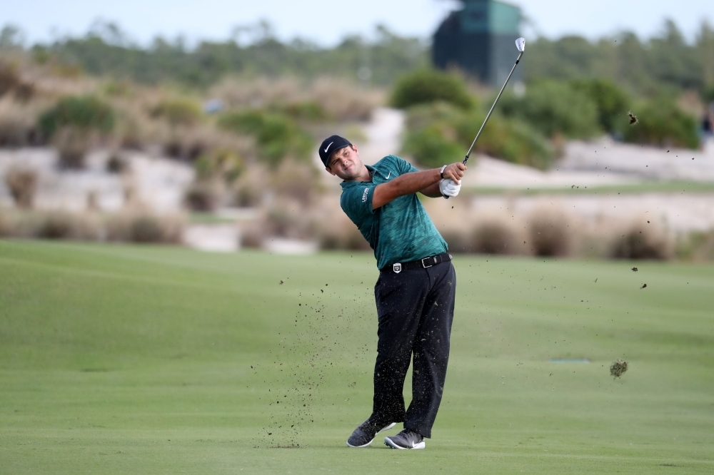 Patrick Reed of the United States hits his second shot into the 18th green during round one of the Hero World Challenge at Albany, Bahamas on Thursday in Nassau, Bahamas. — AFP