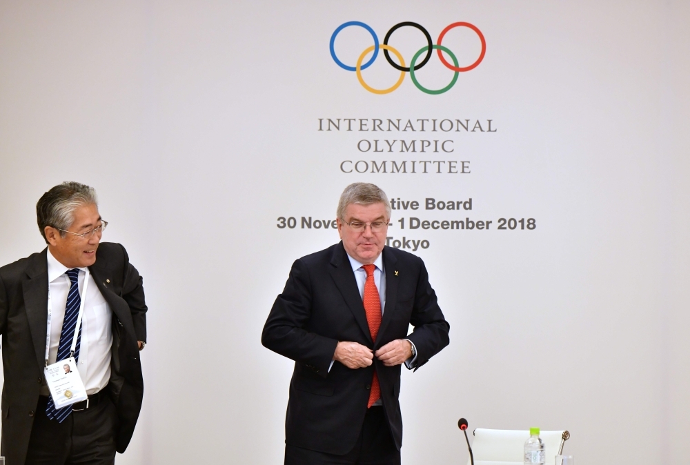 International Olympic Committee (IOC) President Thomas Bach (R) and Tsunekazu Takeda (L), President of the Japanese Olympic Committee, leave after the IOC Executive Board meeting in Tokyo on Friday. — AFP