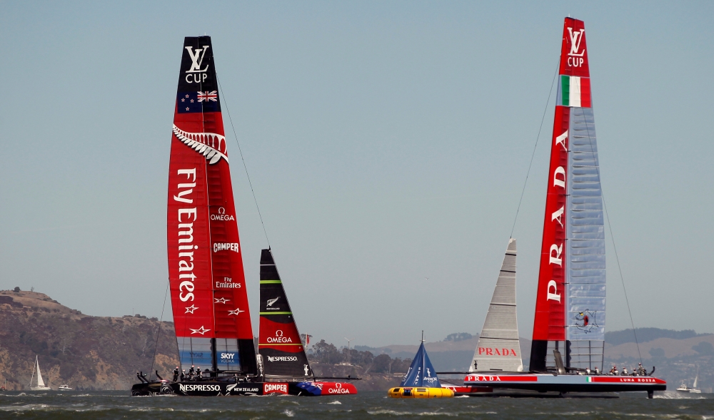 Emirates Team New Zealand (L) and Italy's Luna Rossa Challenge sail on separate tacks during the seventh race of the Louis Vuitton Cup challenger series yacht race in San Francisco, California, in this file photo. — Reuters
