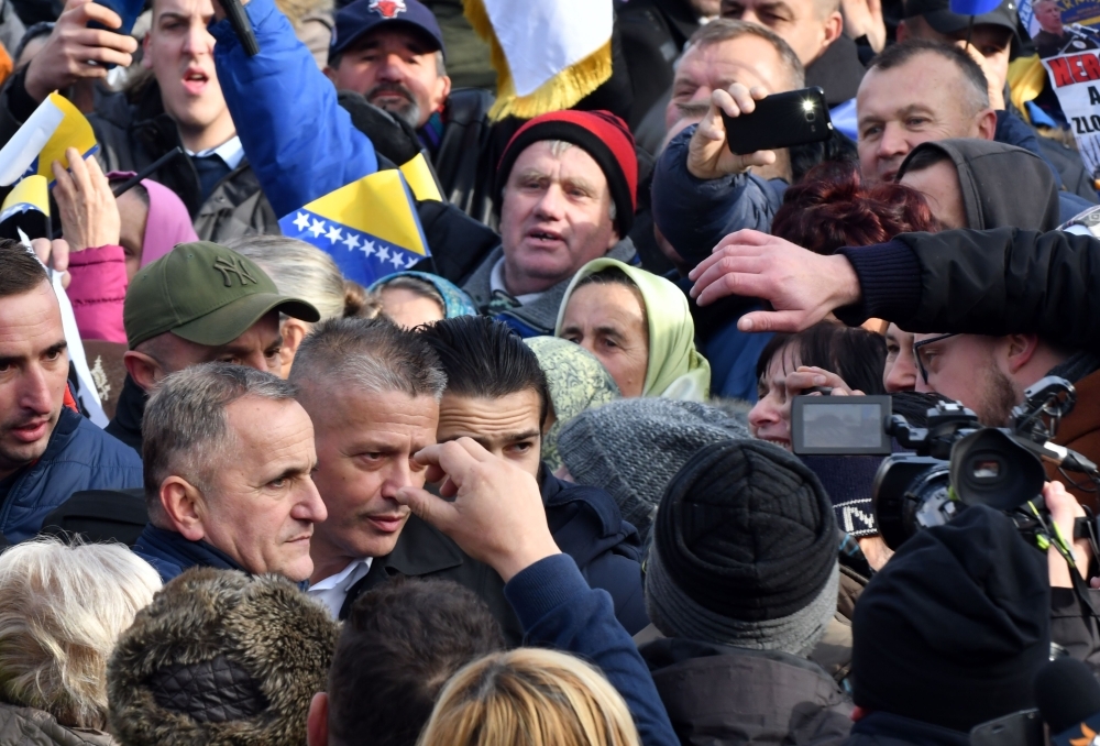 War time commander of Bosnian Muslim fighters in Srebrenica, Naser Oric (2nd Bottom L) is engulfed by supporters as he leaves Court of Bosnia and Herzegovina, in Sarajevo, on Friday. Oric has been acquitted of war crimes charges and case against him is considered finally closed. Oric stood trial for direct participation in killing of 3 Bosnian Serb prisoners in the vicinity of Srebrenica, in 1992. — AFP