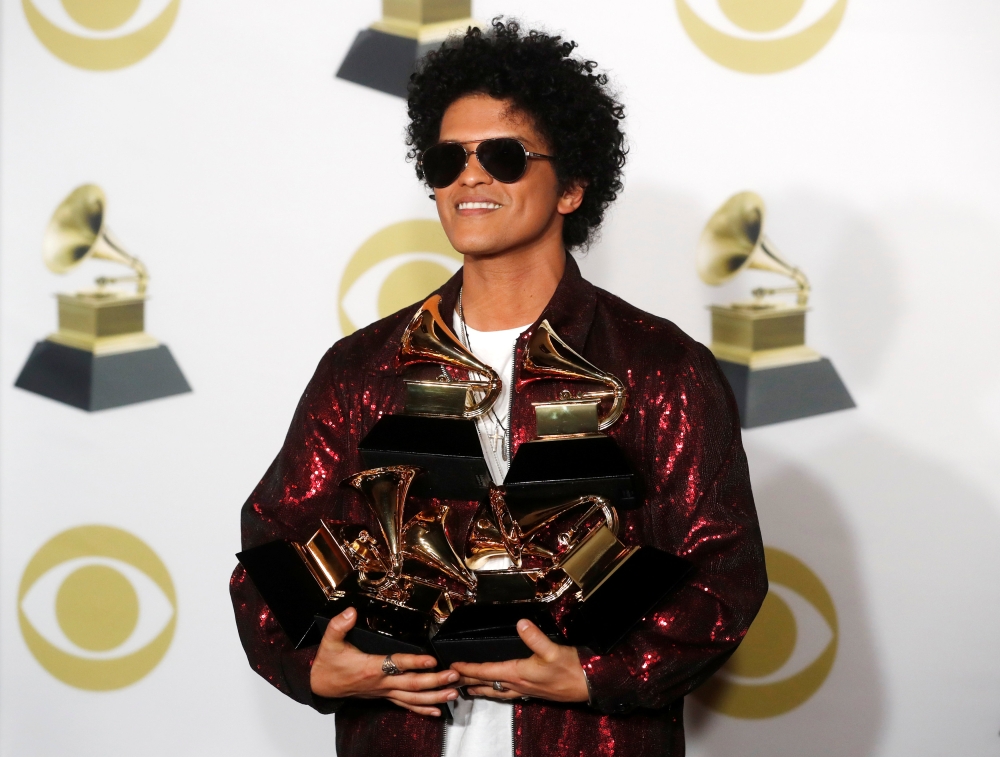 FILE PHOTO: 60th Annual Grammy Awards - Photo Room - New York, U.S., 28/01/2018 - Bruno Mars holds six of seven Grammys which includes Album and Record of the Year for 