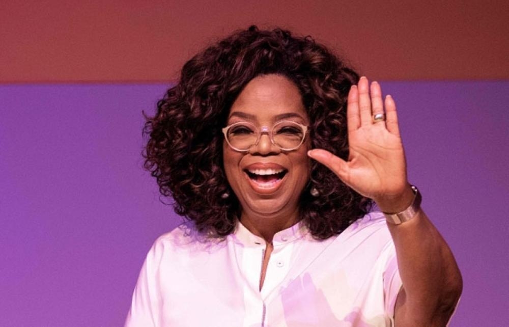 US TV personality Oprah Winfrey waves before delevering a speech during an event to mark 100 years since the birth of Nelson Mandela, at the University of Johannesburg, Soweto Campus, in Johannesburg. — AFP
