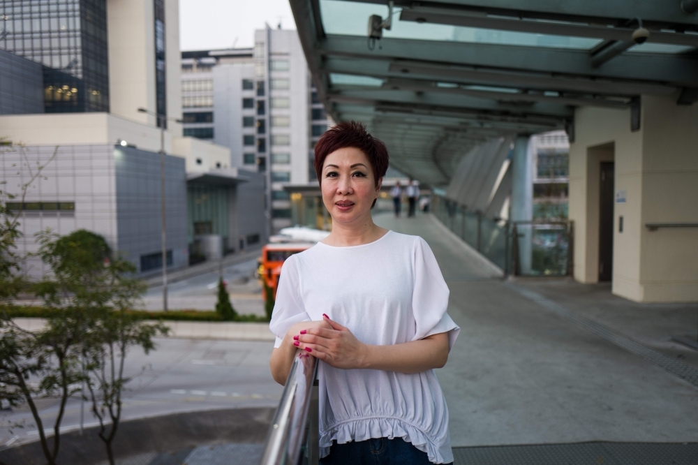 Dora Lai, Cathay Pacific Flight Attendants Union leader and a cabin manager, poses during an interview with AFP in Hong Kong. — AFP