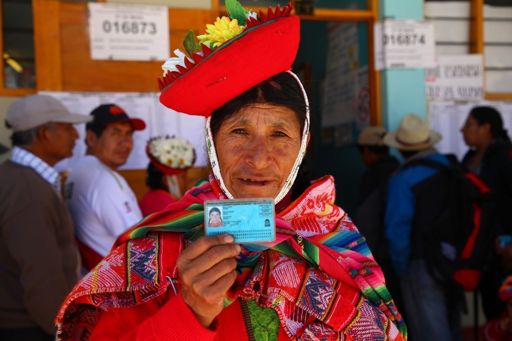A woman shows her identity card at a polling station in Ollantaytambo, a town located in what is known as the Sacred Valley of the Incas in the province of Urubamba, Cusco region, in southern Peru, as the country votes on President Martin Vizcarra’s constitutional reforms aimed at eradicating corruption, on Sunday. — AFP