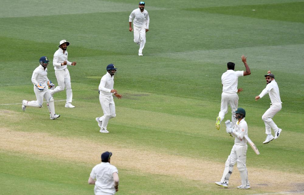 India’s players celebrate after they defeated Australia on day five of the first Test match at the Adelaide Oval Monday. — AFP