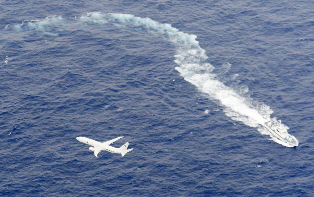 A Japan Coast Guard patrol vessel and US Navy airplane conduct search and rescue operation at the area where two US Marine Corps aircraft have been involved in a mishap in the skies, off the coast of Kochi prefecture, Japan, in this aerial view photo taken by Kyodo Dec. 6, 2018. — Reuters