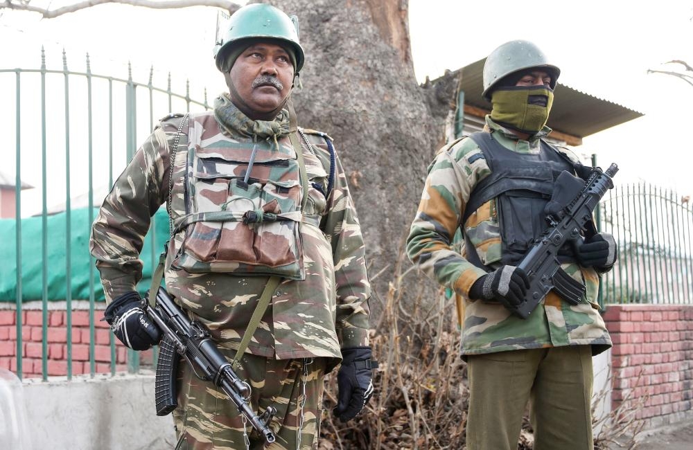 Indian paramilitary personnel stand guard in Srinagar on Tuesday, as security tightens following an attack on a police post at Zainpora village in southern Kashmir valley. — AFP
