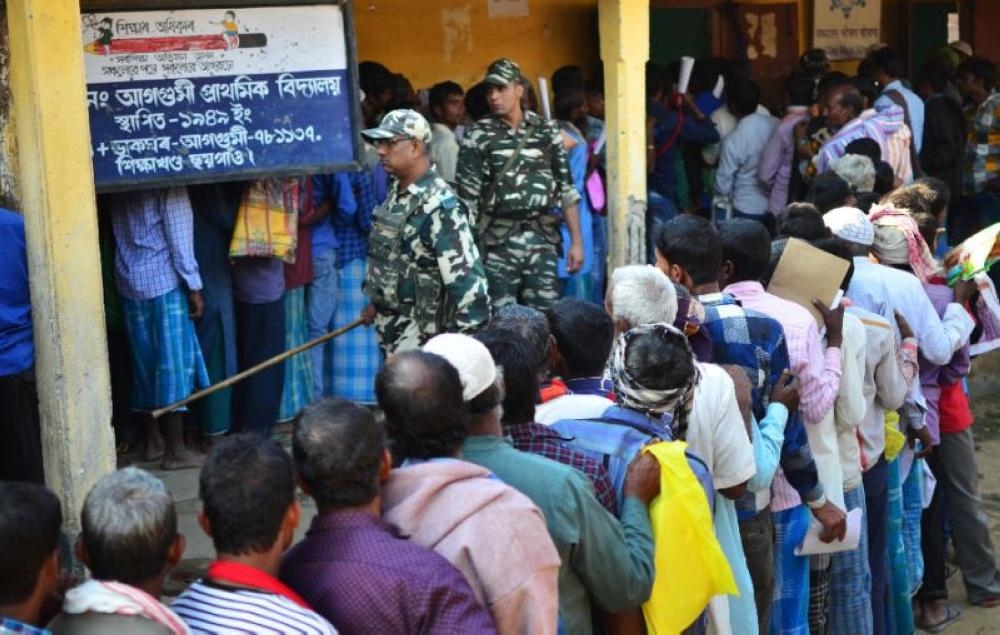 People stand in line to check their names on the first draft of the National Register of Citizens in Assam in this file photo. — AFP