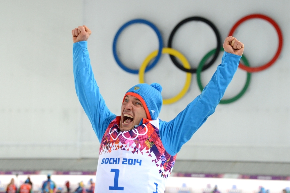 In this file photo, bronze medalist Russia's Evgeniy Garanichev celebrates during the Men's Biathlon 20 km Individual Flower Ceremony at the Laura Cross-Country Ski and Biathlon Center during the Sochi Winter Olympics in Rosa Khutor near Sochi. Austrian prosecutors announced on Thursday that members of Russia's biathlon team are being investigated over alleged doping offenses dating back to the World Championships in 2017 in the Austrian town of Hochfilzen. Garanichev said: 