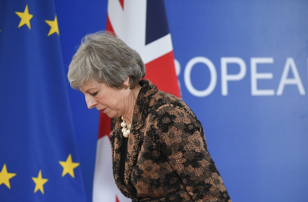 Britain’s Prime Minister Theresa May leaves after speaking during a press conference on Friday in Brussels during the second day of a European Summit aimed at discussing the Brexit deal, the long-term budget and the single market. — AFP