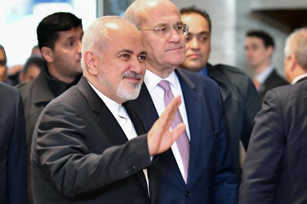 Iranian Foreign Minister Mohammad Javad Zarif (center-left) arrives for a meeting with UN Syria envoy and foreign ministers of Turkey and Russia, at the United Nations Offices in Geneva on Monday. — AFP