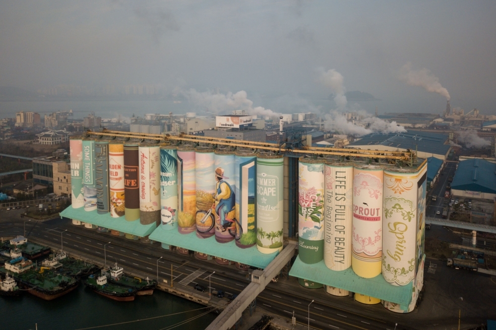 A mural listed by the Guinness World Records as the largest in the world is displayed on a grain silo in Incheon port, west of Seoul.  According to the Korea Times, the Incheon city government and Incheon Port Authority commissioned 22 painting artists and spent 487,000USD on the project, which started in January this year. — AFP