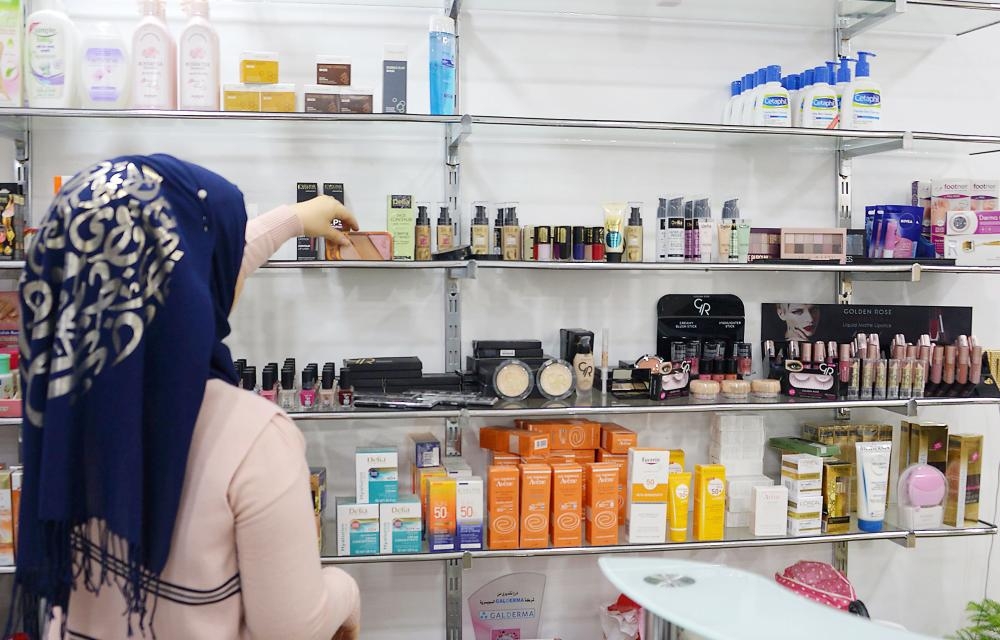 A beautician arranges products for sale. — AFP photos