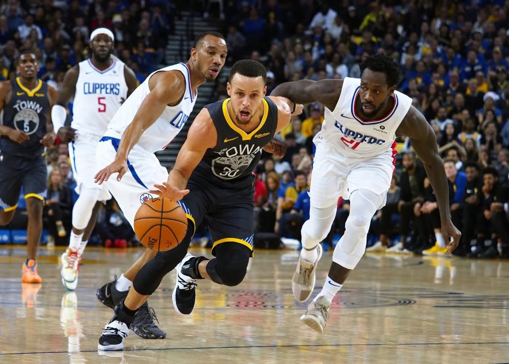 Golden State Warriors’ guard Stephen Curry drives in against LA Clippers during their NBA game at Oracle Arena in Oakland Sunday. — Reuters