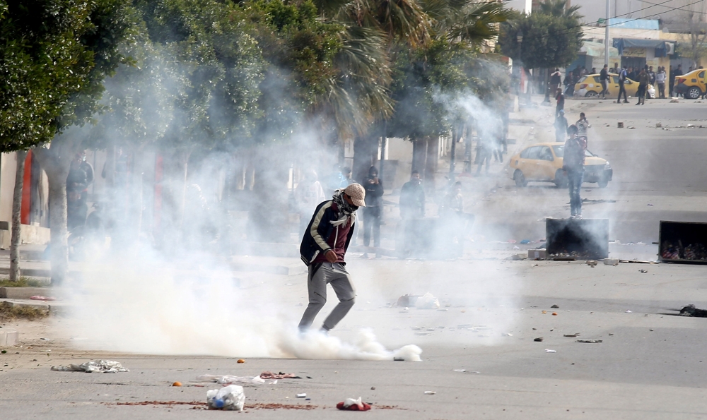 Riot police clash with protesters during demonstrations in Kasserine, Tunisia on Tuesday.  