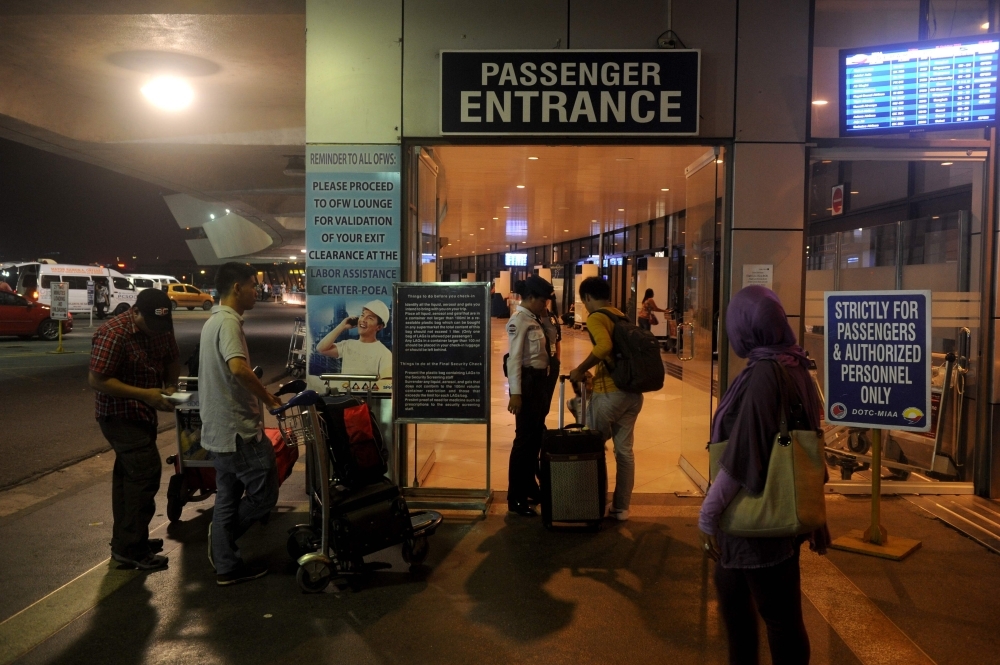 Passengers arrive at Ninoy Aquino International Airport for their flights in Manila in this Oct.18, 2013 file photo. — AFP