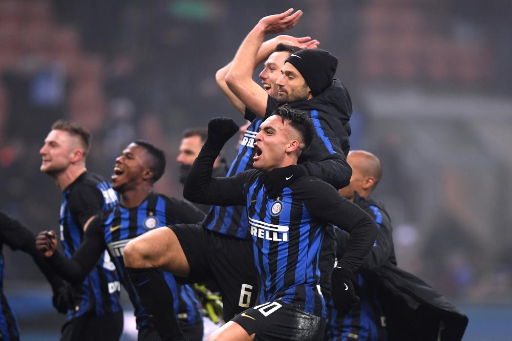 Inter Milan's Lautaro Martinez celebrates with teammates after the match against Napoli at San Siro Wednesday. — Reuters