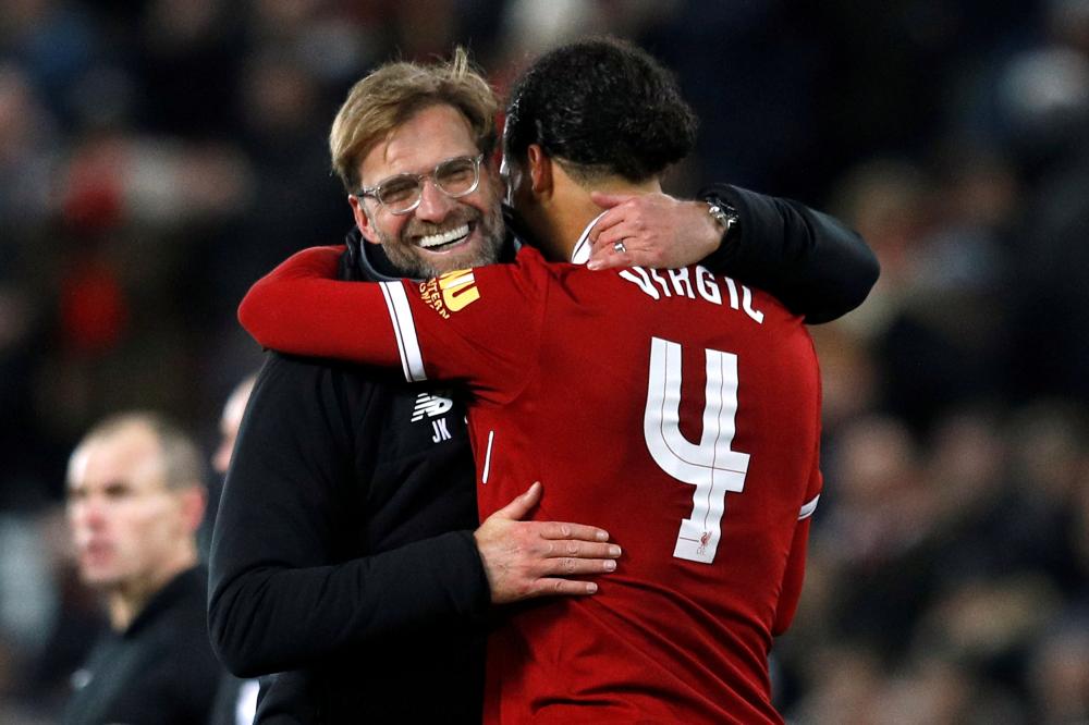 Liverpool manager Juergen Klopp celebrates with Virgil van Dijk. — AFP