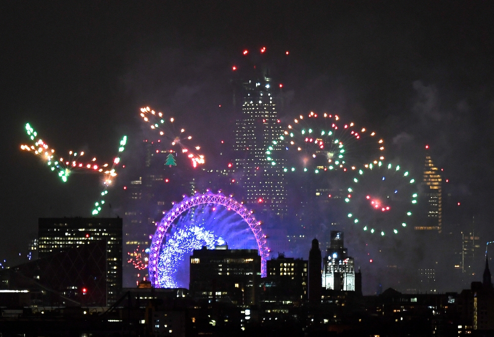 Fireworks light up the sky around the London Eye wheel to welcome the New Year in London. — Reuters